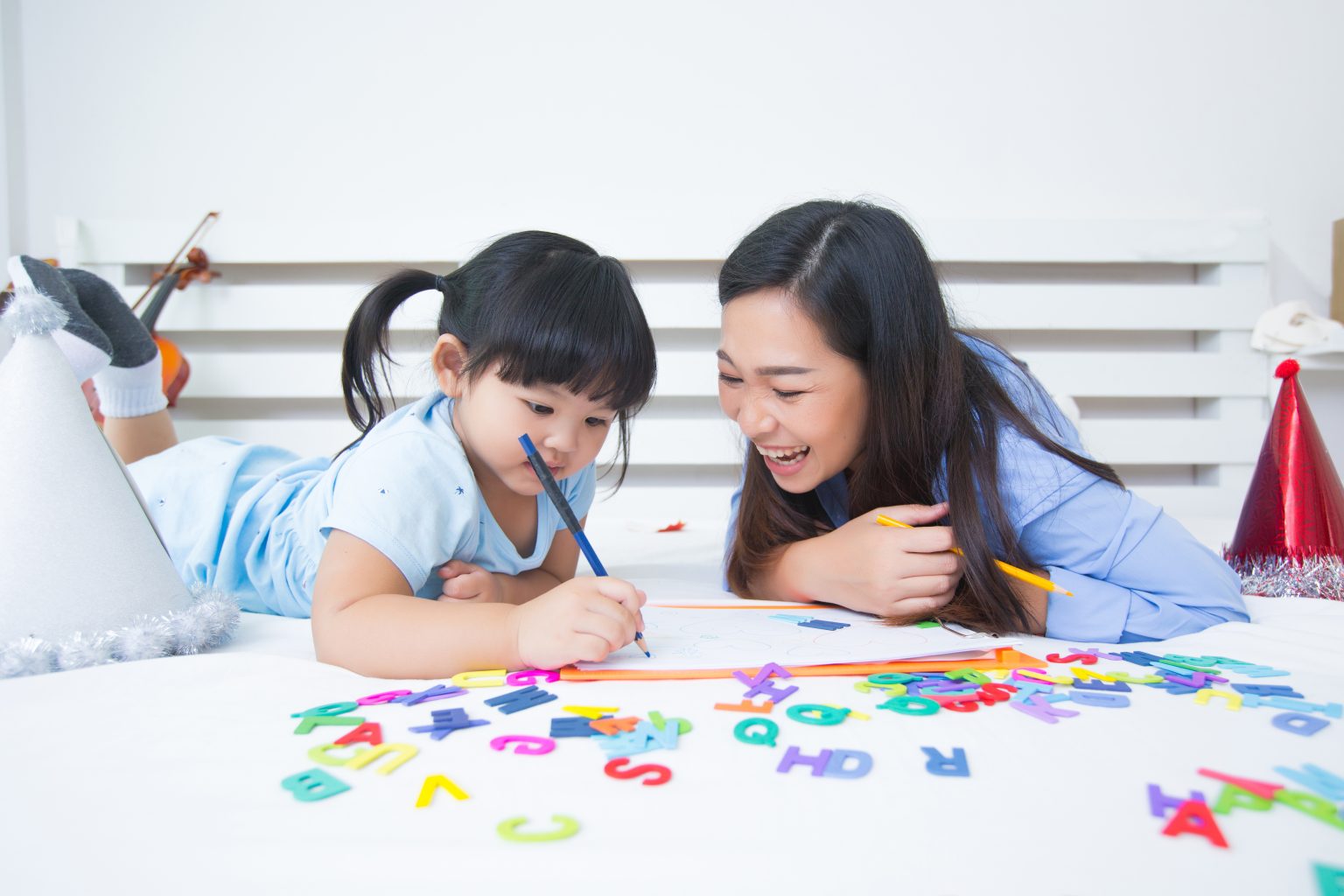Ibu dan anak bermain tebak gambar untuk melatih bahasa dan kosakata.