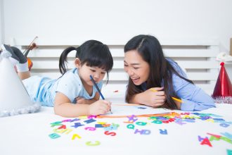 Ibu dan anak bermain tebak gambar untuk melatih bahasa dan kosakata.